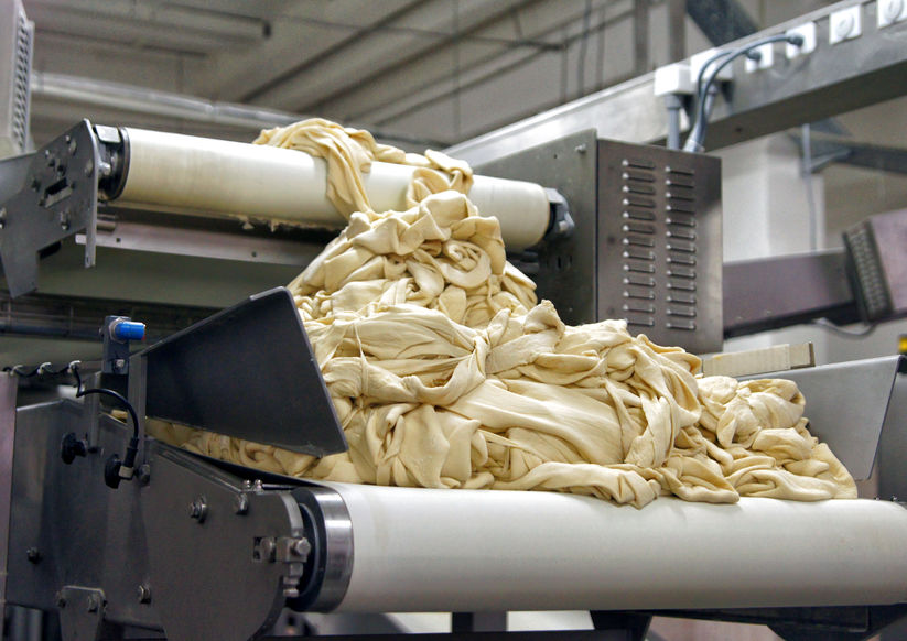 Dough on the conveyor.